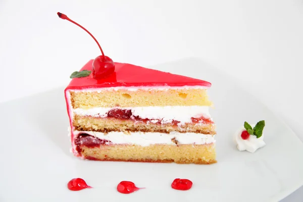 Slice of fresh cherries cake with a fresh cherry on top