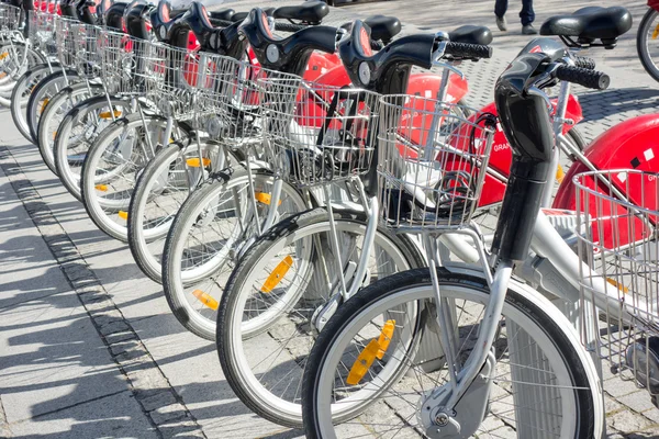 LYON, FRANCE - on APRIL 15, 2015 - Shared bikes are lined up in the streets of Lyons, France. Velo\'v Grand Lyon has over 340 stations and 3000 bikes throughout the Grand Lyon area.