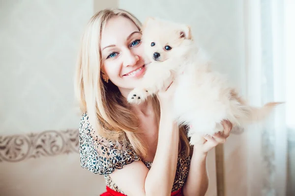 Beautiful Blonde Woman with Her Dog in a Beautiful Interior
