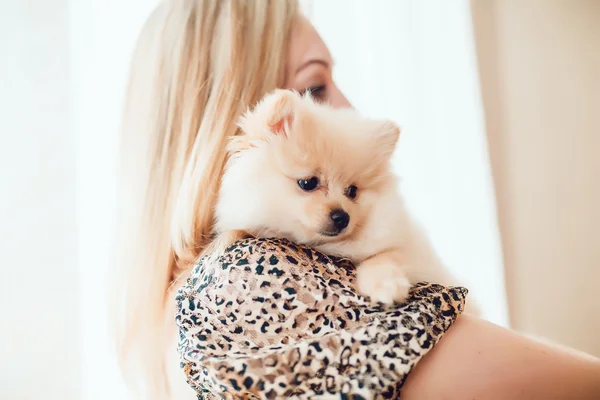 Beautiful Blonde Woman with Her Dog in a Beautiful Interior