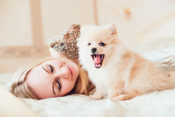 Beautiful Blonde Woman with Her Dog in a Beautiful Interior