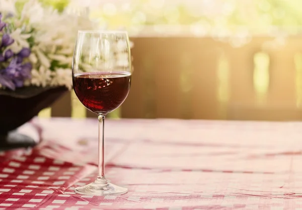 Glass of red wine on natural background