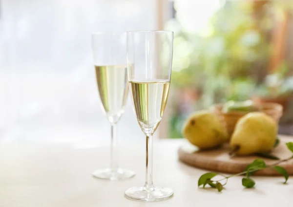 Two glasses of white wine on natural background