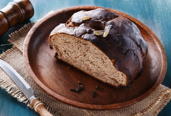 Homemade rye bread over wooden background