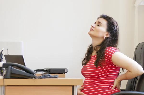 A pregnant woman strongly sore back in the office