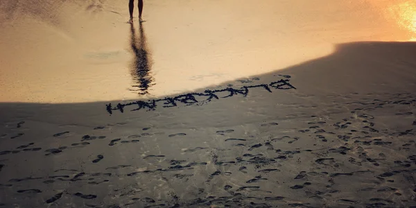 Inscription \'Black beach\' on black sand