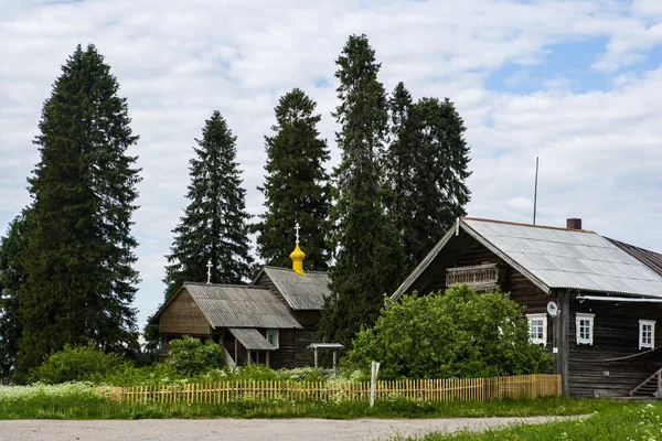 Old wooden buildings and small orthodox church