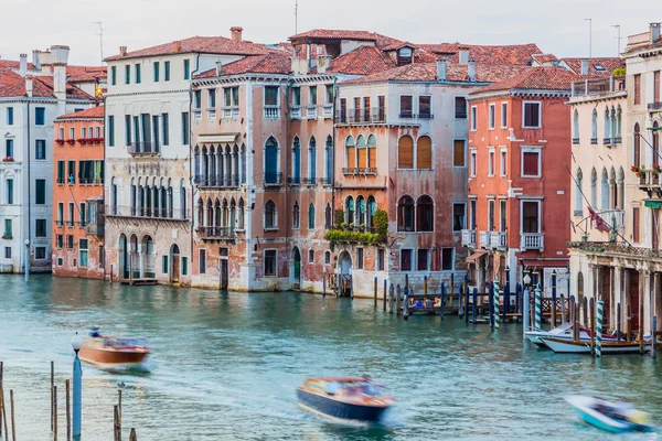 Venice, Italy - June 27, 2014: Evening view on colorful residential houses built directly on Grand Canal. View from Rialto bridge.