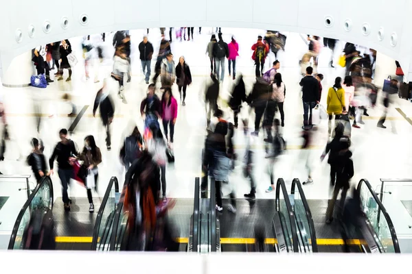 Motion blurred crowded people shopping in mall