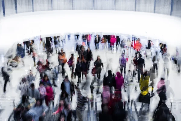 Motion blurred crowded people shopping in mall