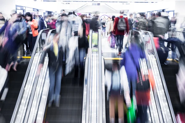 Motion blurred crowded people shopping in mall