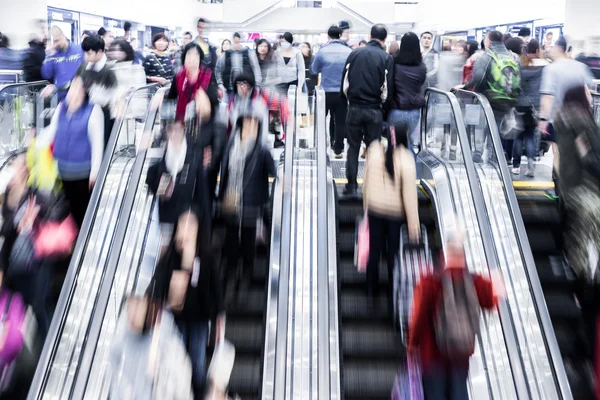 Motion blurred crowded people shopping in mall