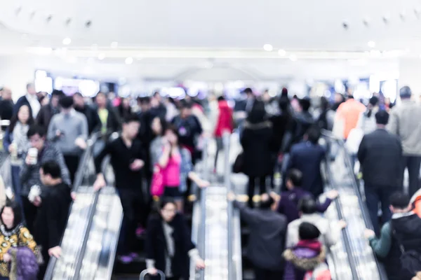 Motion blurred crowded people shopping in mall