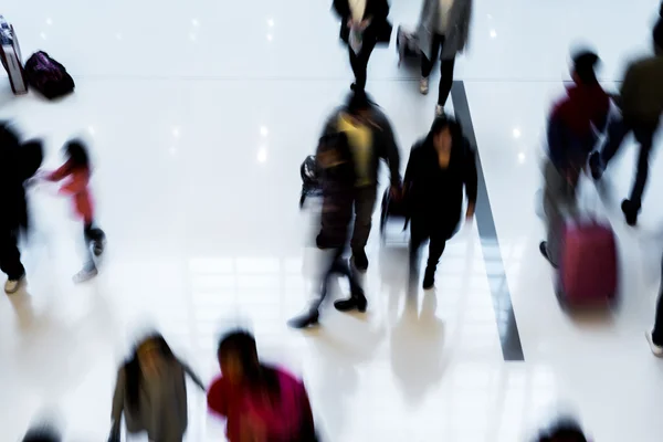 Motion blurred crowded people shopping in mall