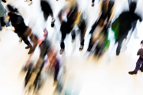 Motion blurred crowded people shopping in mall