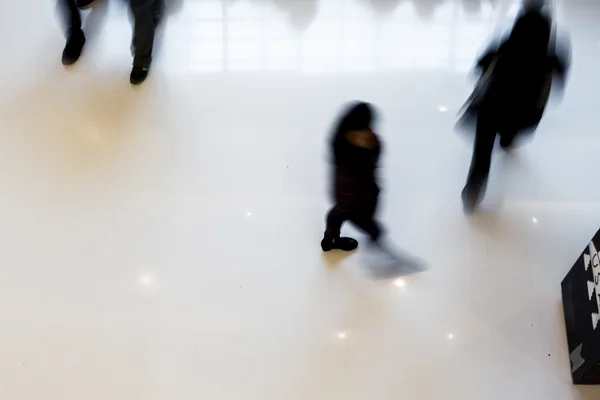 Motion blurred crowded people shopping in mall