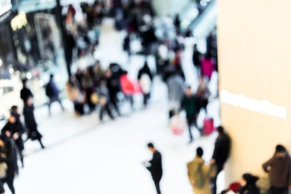 Motion blurred crowded people shopping in mall