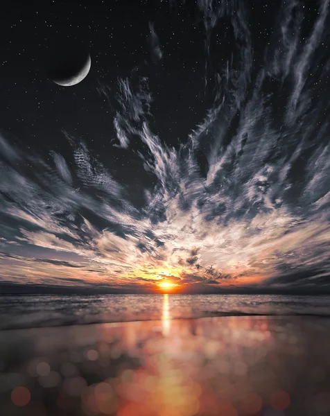 Beautiful sunset on the beach, stars and moon on the sky