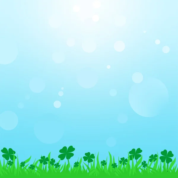 Summer landscape with green grass with clover leaf with a blue sky with the sun and sun reflections