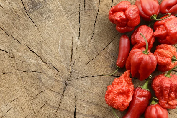 Hot peppers on wooden background