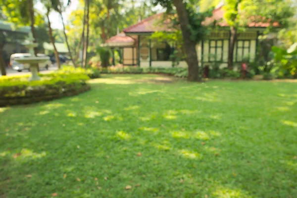 Abstract blurry antique Thai style home with green garden background