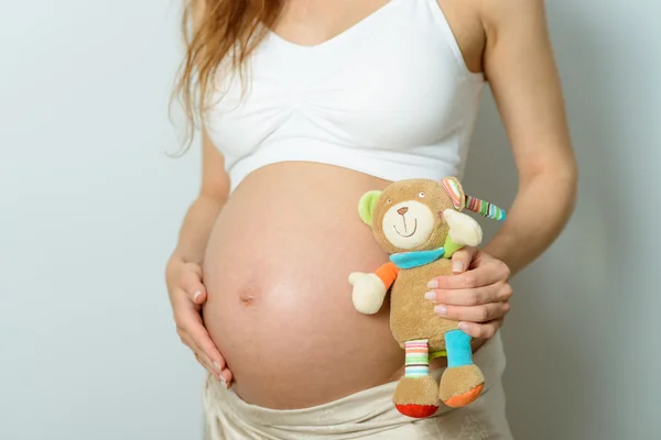 Pregnant belly and toy