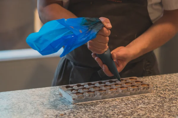 Hands of worker by chocolate production