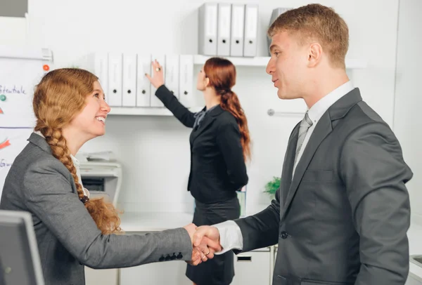 Handshake of man and woman in suit