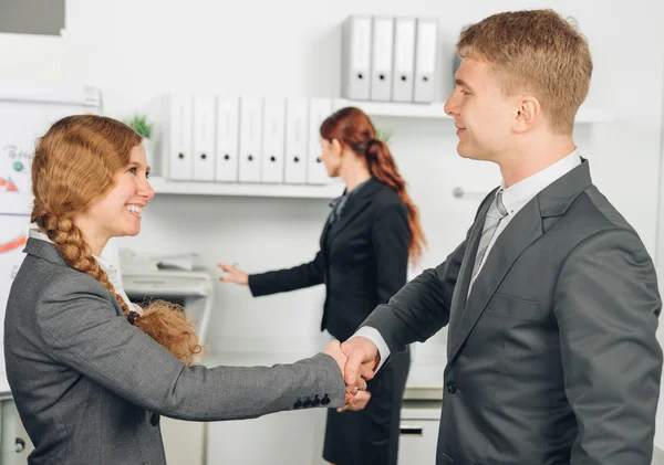 Handshake of man and woman in suit