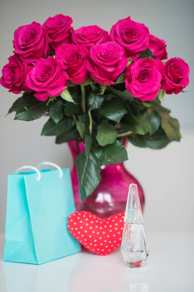 Bouquet of pink roses in a vase and  present to 14 february