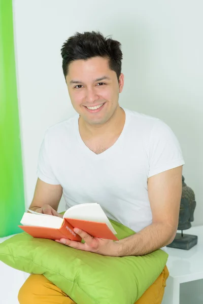 Young man with a book at home