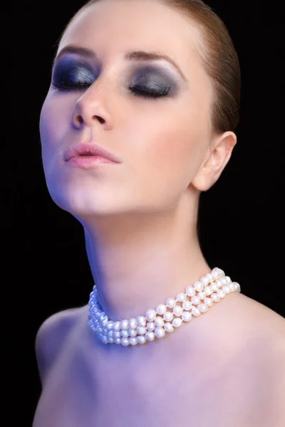 Fashion portrait of beautiful woman with pearl necklace