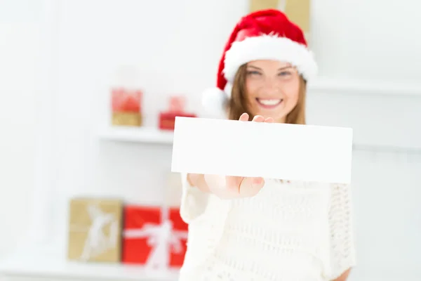 Santa girl peeking from behind blank sign billboard. Advertising