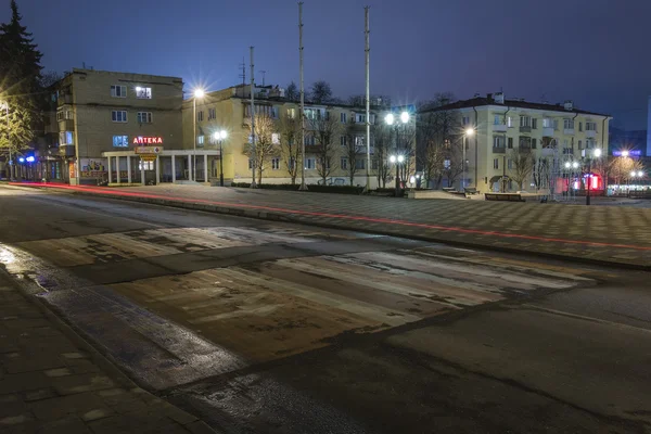 Traces of passing cars on the night street