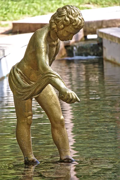 Statue of a boy in water near Mirror Pond