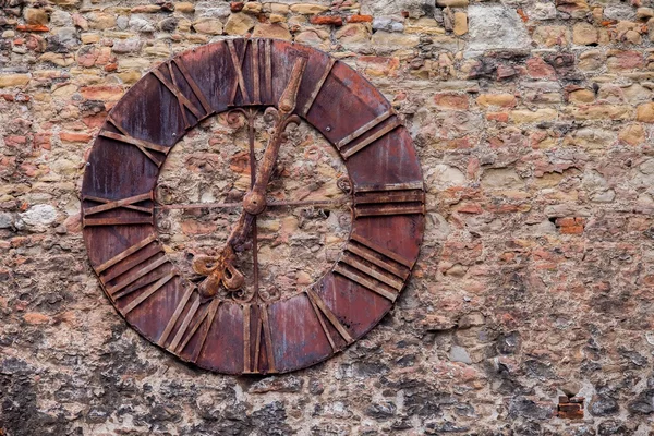 Old steel clock on the castle wall