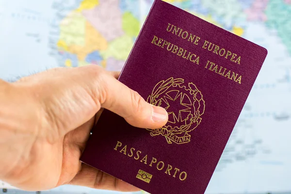 Hand holds an Italian Passport