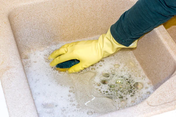 Clean a granite sink with a sponge