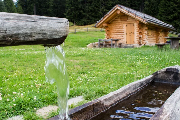 Wooden trough with spring water in a farmhouse