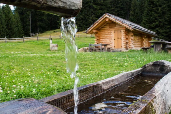 Wooden trough with spring water in  a  farmhouse