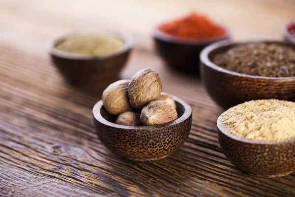 Spices and herbs in wooden bowls