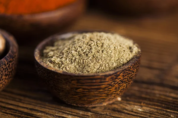 Spices and herbs in wooden bowls