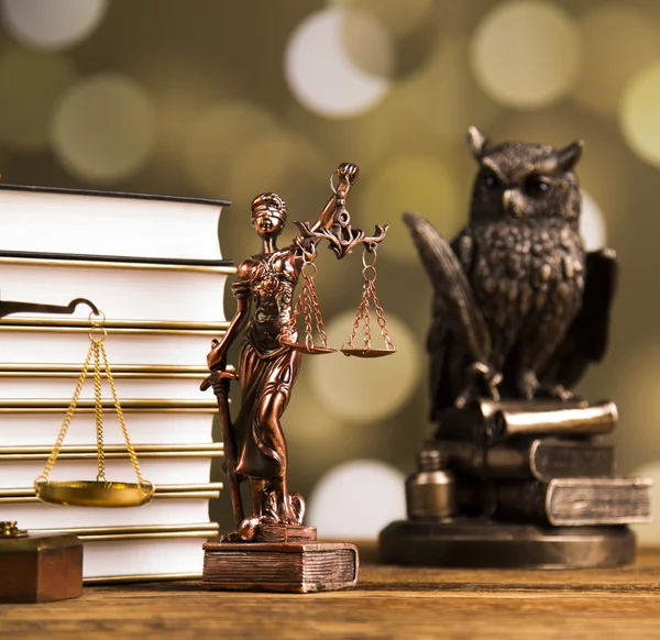 Golden scales of justice, books, Statue of Lady Justice. Owl and paragraph