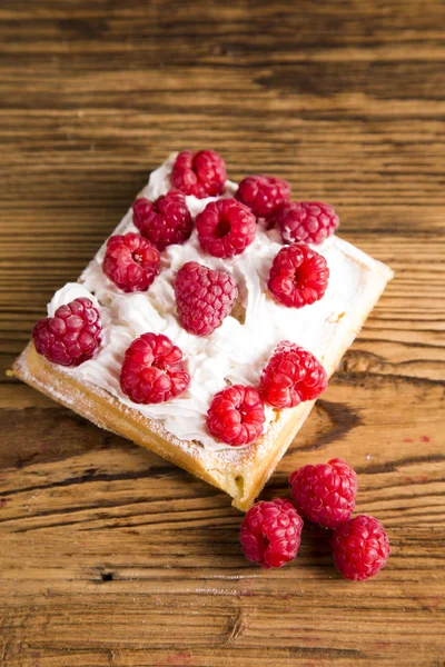 Waffles with whipped cream and raspberries and cranberries,  Waffles with icing sugar