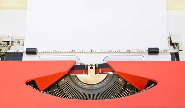 Close up image of red typewriter with paper sheet. copy space for your text.
