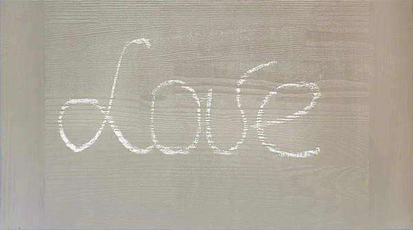 Hand written love word on grey chalkboard