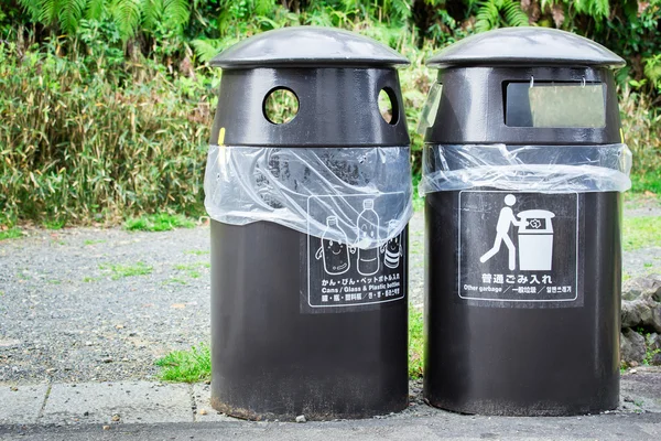 Closeup black trash can with plastic bag