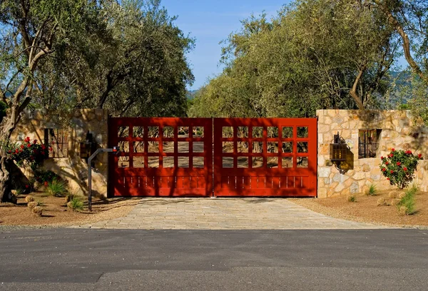 Private driveway with red gates