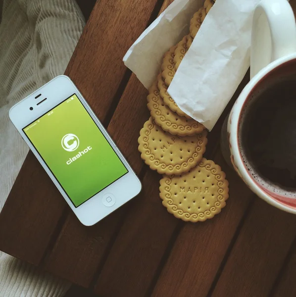 Breakfast with biscuits, cup of coffee and iPhone with Clashot logo