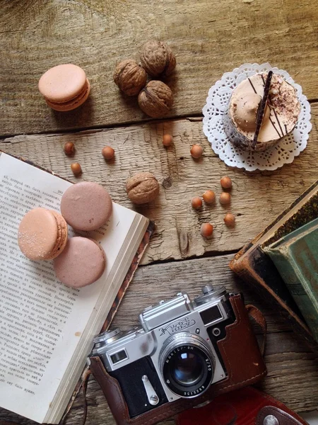 Macaroons, cake, nuts, old  camera and books